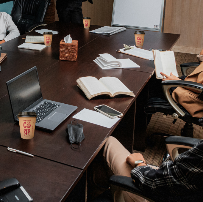 a group of people sitting around a conference table